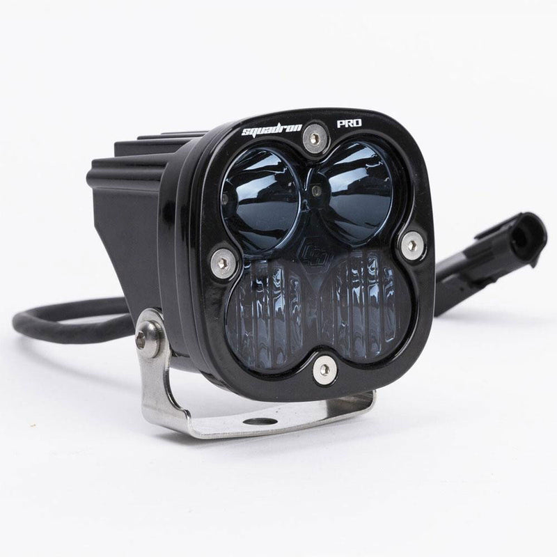 Baja Designs Squadron Pro Infrared LED Light Pod, whole product on a studio background: A black Squadron Pro LED pod with a smoked lens showing two optics over a textured lower section, on white
