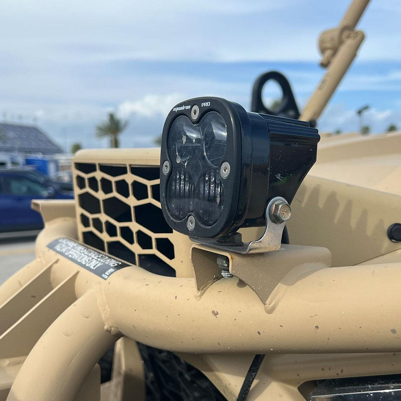 Baja Designs Squadron Pro Infrared LED Light Pod on a vehicle: A Squadron Pro pod with a smoked lens bolted to a tan tube frame vehicle cowl under a blue sky