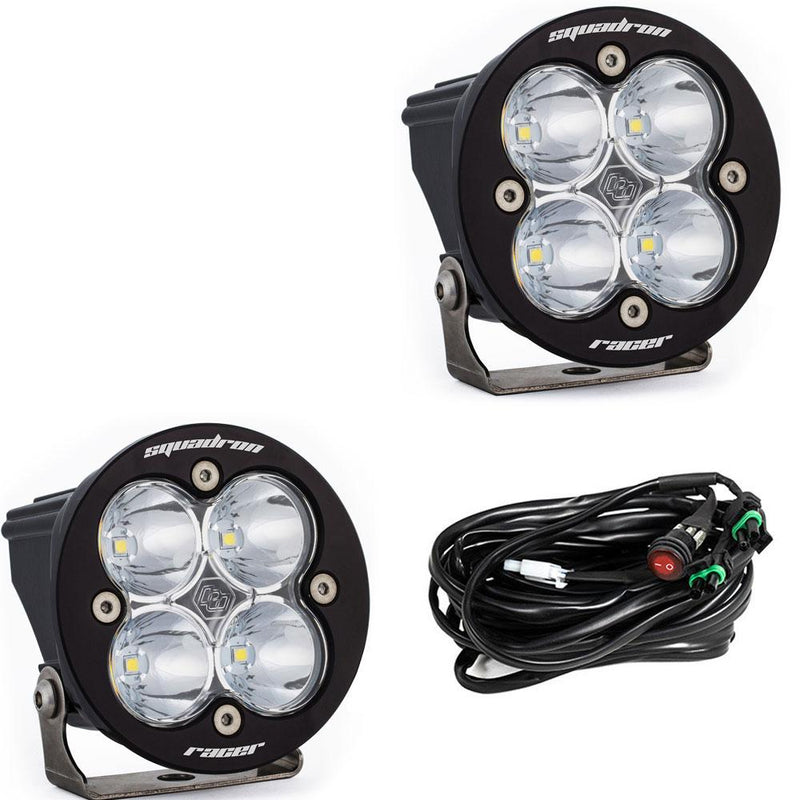 Baja Designs Squadron-R Racer Edition LED Auxiliary Light Pod Pair, whole product on a studio background: two round black Squadron-R Racer Edition pods with clear lenses and a wiring harness on a white background