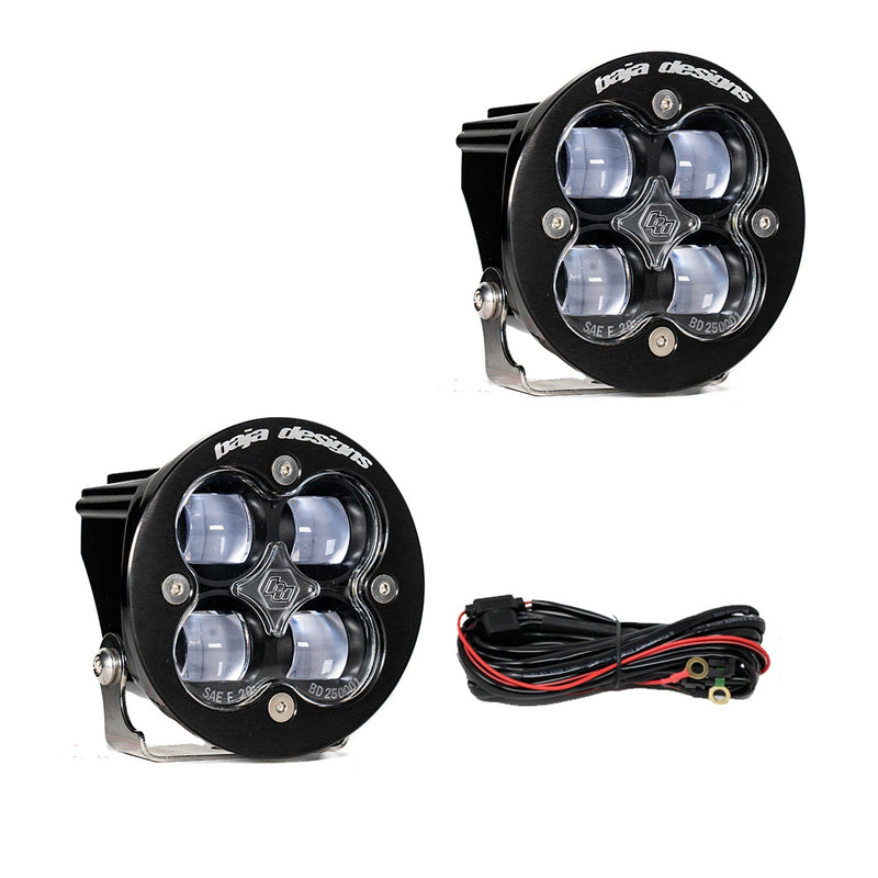 Baja Designs Squadron-R SAE LED Auxiliary Light Pod Pair, whole product on a studio background: two round black Squadron-R SAE pods with clear lenses and a wiring harness on a white background