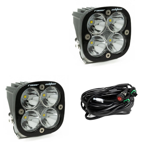 Baja Designs Squadron Racer Edition LED Auxiliary Light Pod Pair, whole product on a studio background: two black Squadron Racer Edition pods with clear lenses and a wiring harness on a white background