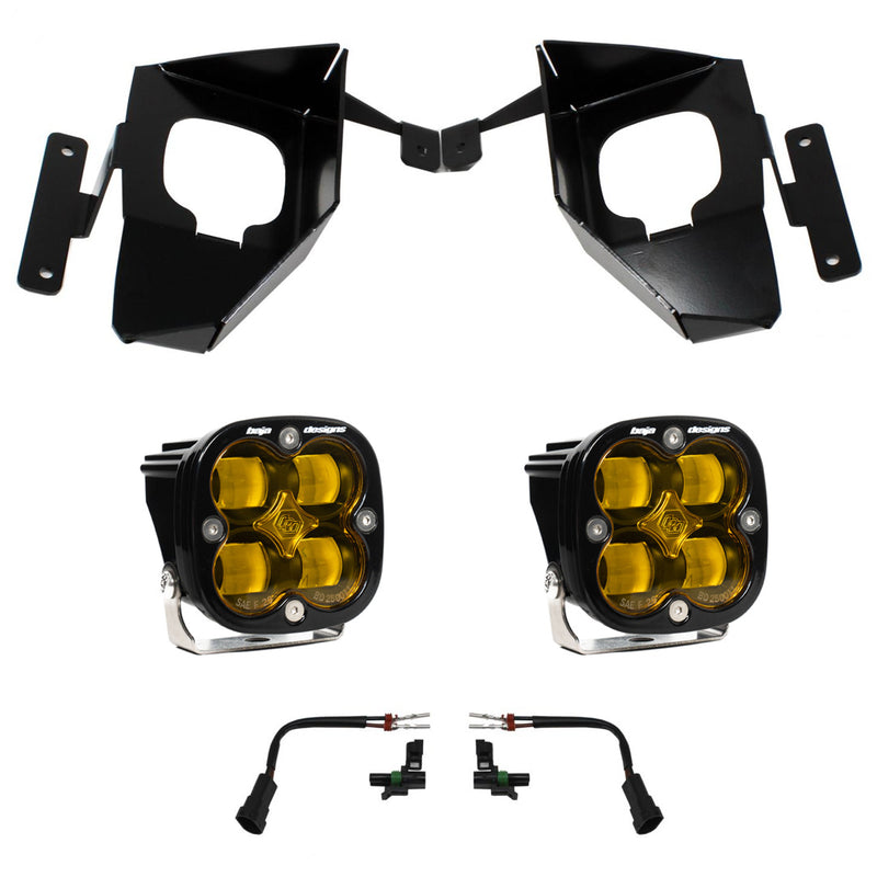 Baja Designs Squadron SAE Fog Pocket Light Kit, complete kit on a studio background: pair of black Squadron SAE fog pods with amber lenses, two black fog pocket brackets and two adapter harnesses on white; amber lens while sibling SKU 447535 is the