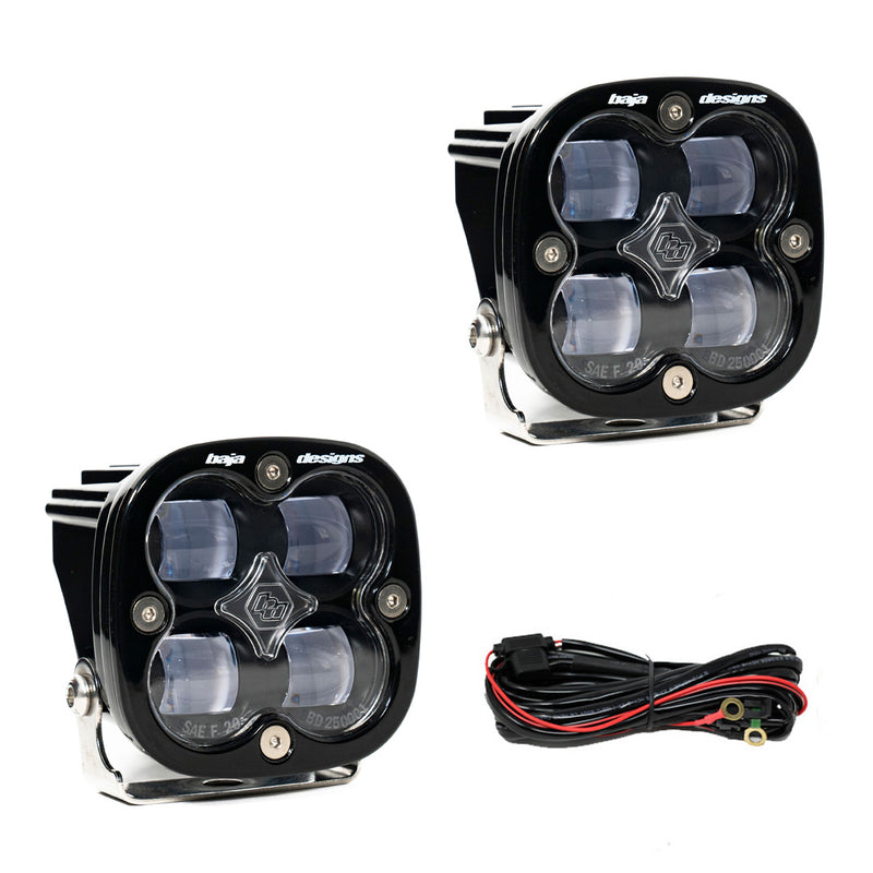 Baja Designs Squadron SAE LED Auxiliary Light Pod Pair, whole product on a studio background: two square black Squadron SAE pods with clear lenses and a wiring harness on a white background