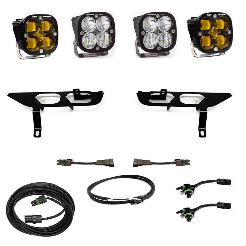 Baja Designs Squadron SAE/Pro Fog Pocket Light Kit, complete kit on a studio background: four black Squadron pods, two amber and two clear, two black fog pocket brackets, adapter harnesses and coiled cables on white