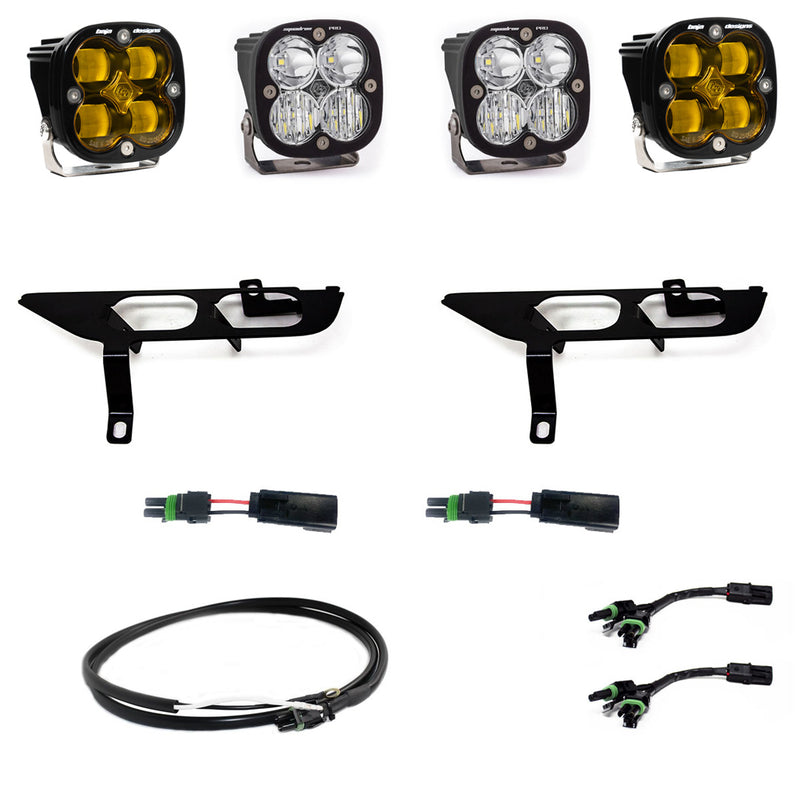 Baja Designs Squadron SAE/Pro Fog Pocket Light Kit, complete kit on a studio background: four square Squadron pods, two black fog pocket brackets, pigtail adapters and harness, two amber and two clear lenses laid out on a white background