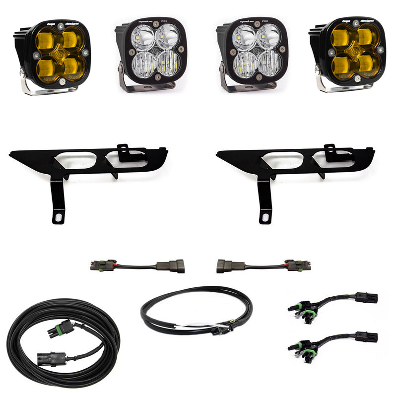 Baja Designs Squadron SAE/Sport Fog Pocket Light Kit, complete kit on a studio background: four black Squadron pods, two amber and two clear, two black fog pocket brackets, adapter harnesses and coiled cables on white; sibling 447698 is the amber kit