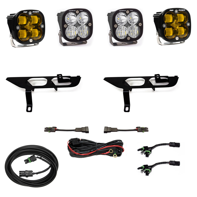 Baja Designs Squadron SAE/Sport Fog Pocket Light Kit, complete kit on a studio background: four black Squadron pods, two with amber lenses and two clear, two black fog pocket brackets, a red relay harness, adapter harnesses and coiled extension