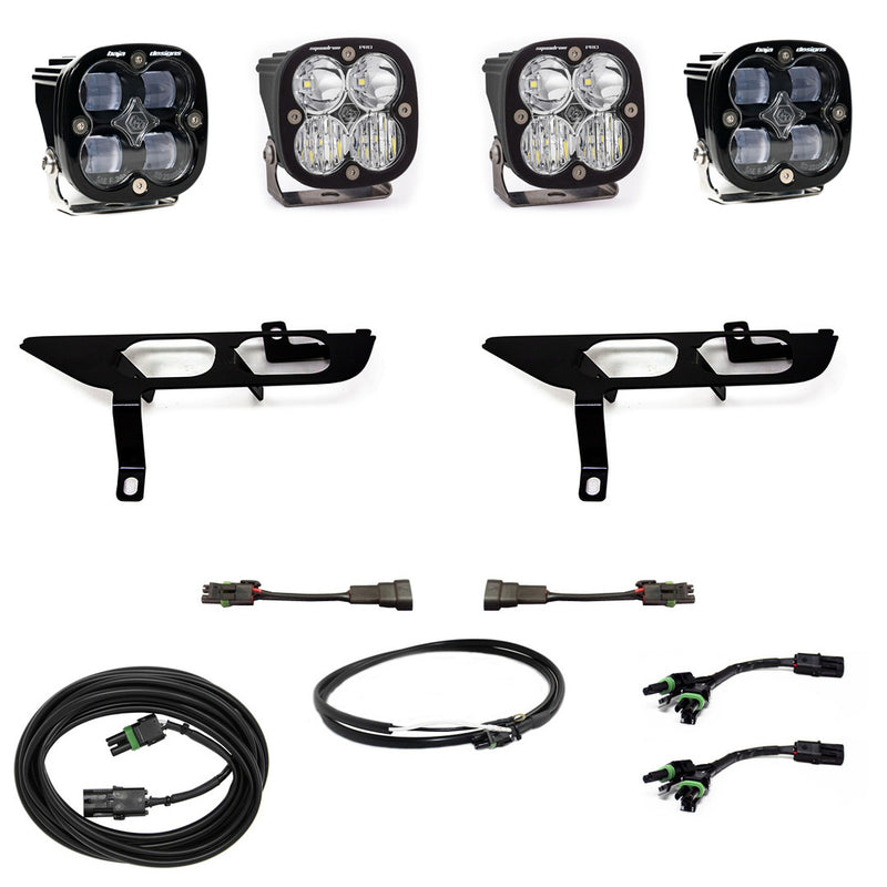 Baja Designs Squadron SAE/Sport Fog Pocket Light Kit, complete kit on a studio background: four black Squadron pods with clear lenses, two black fog pocket brackets, adapter harnesses, a black jumper cable and a coiled extension cable on white