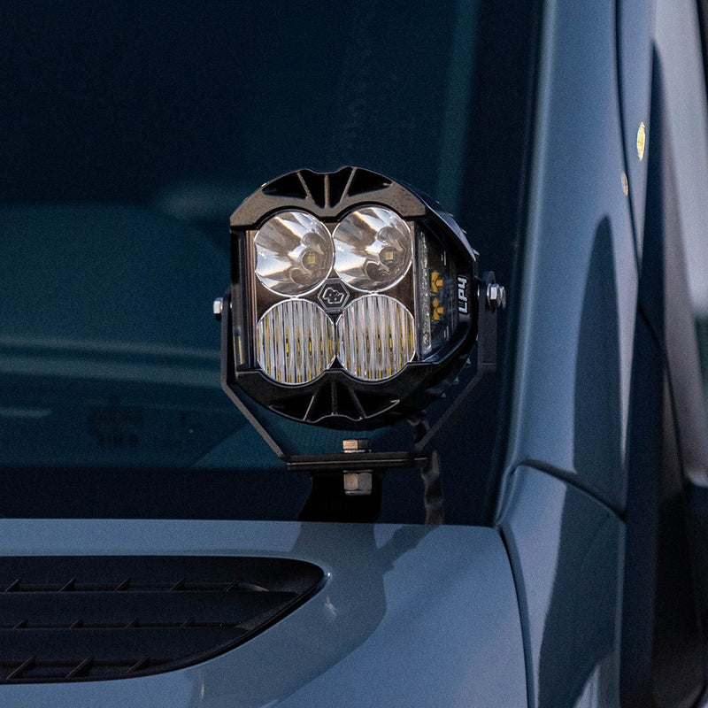 Baja Designs Van LP4 A-Pillar Kit on a Mercedes-Benz Sprinter: an LP4 LED pod mounted on an A-pillar bracket beside the windshield of a blue-gray van