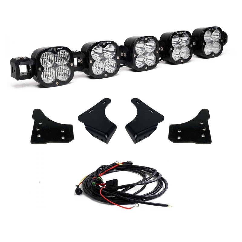 Baja Designs XL Linkable Bumper Light Kit, complete kit on a studio background: A five-pod XL Linkable light bar kit on white with four bumper brackets and a relay wiring harness