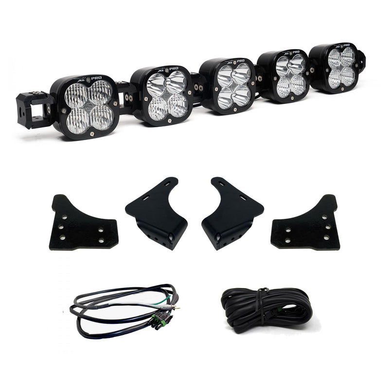 Baja Designs XL Linkable Bumper Light Kit, complete kit on a studio background: A five-pod XL Linkable light bar kit on white with four bumper brackets, a pigtail harness and a coiled extension harness