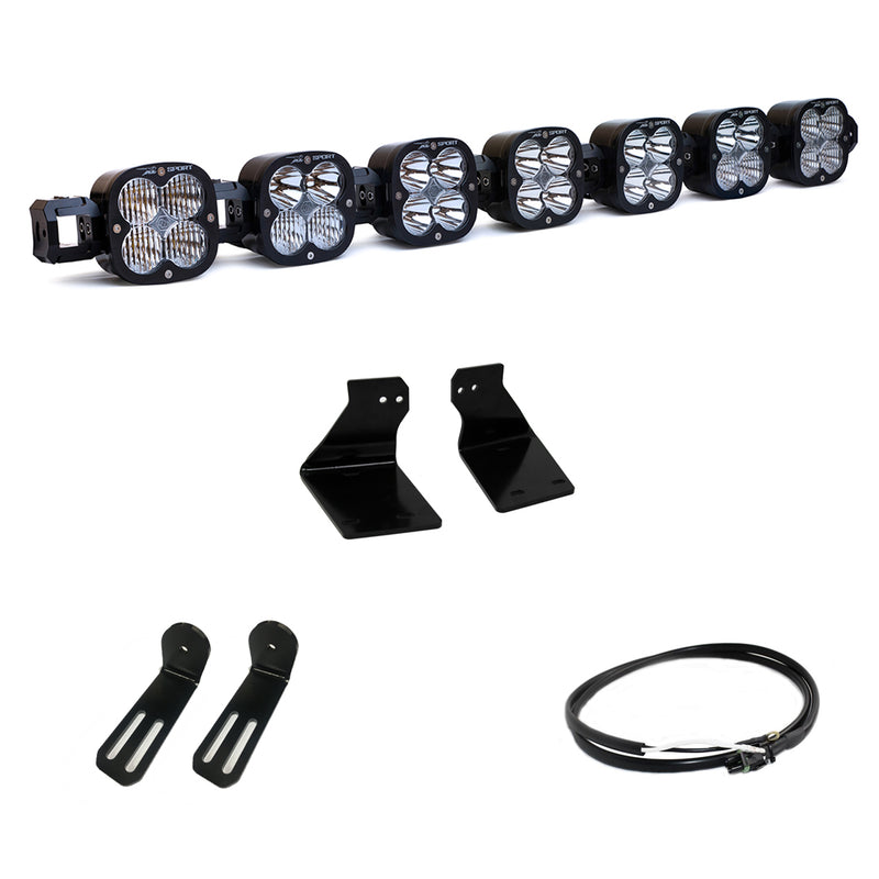 Baja Designs XL Linkable Bumper Light Kit, complete kit on a studio background: A seven-pod XL Linkable light bar kit on white with two bumper brackets, two slotted mounts and a short coiled pigtail harness