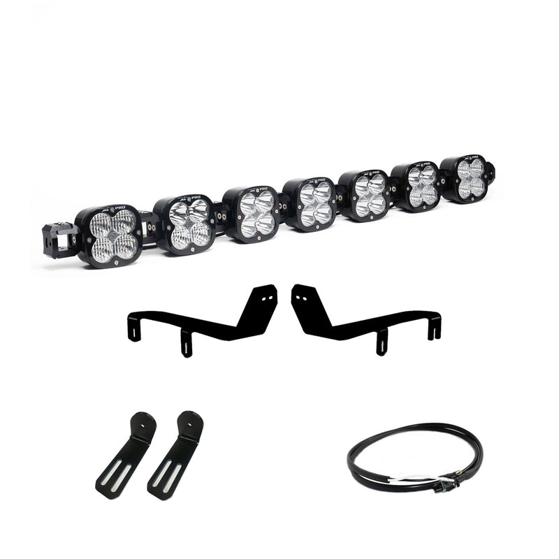 Baja Designs XL Linkable Bumper Light Kit, complete kit on a studio background: A seven-pod XL Linkable light bar with four black brackets and a cable on white
