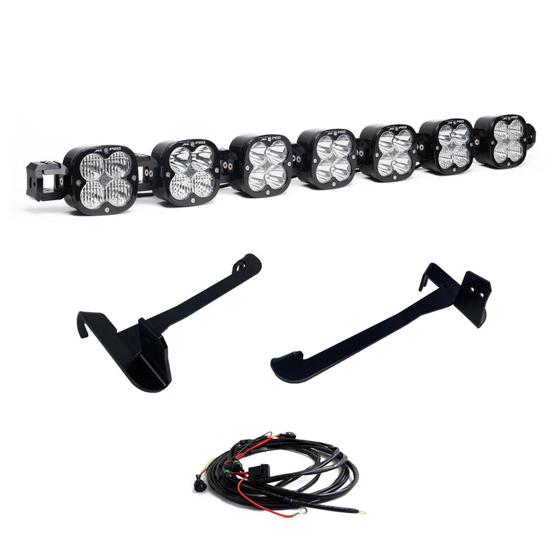 Baja Designs XL Linkable Bumper Light Kit, complete kit on a studio background: seven XL Pro linkable pods joined as one bar with two long black mounting brackets and a wiring harness on white