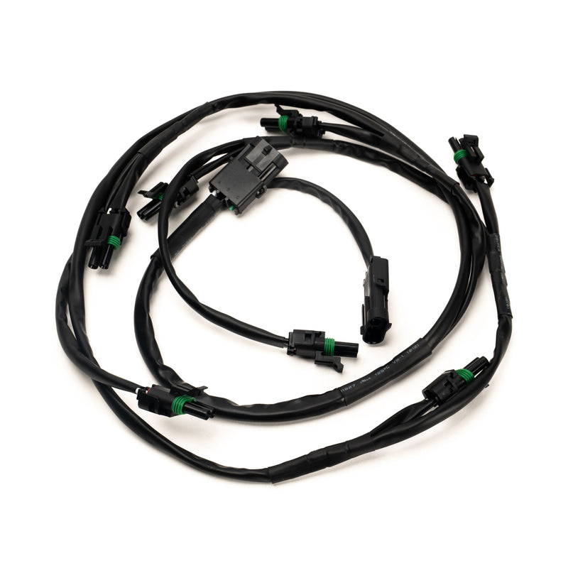 Baja Designs XL Linkable Wiring Harness, whole product on a studio background: A black linkable wiring harness with a main connector and several weatherproof light pigtails on a white background