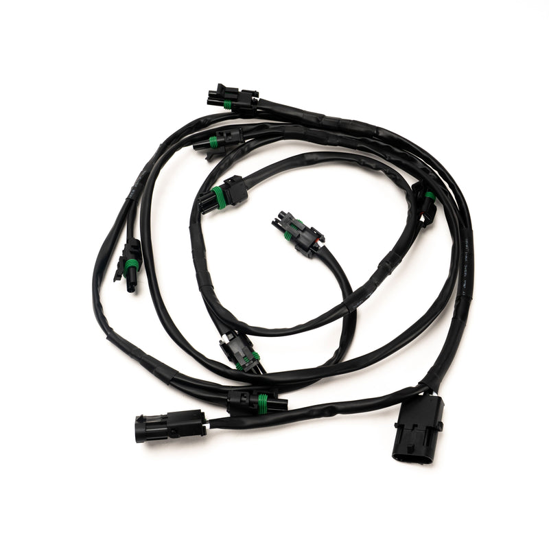 Baja Designs XL Linkable Wiring Harness, whole product on a studio background: A black linkable wiring harness with a main connector and several weatherproof light pigtails on a white background