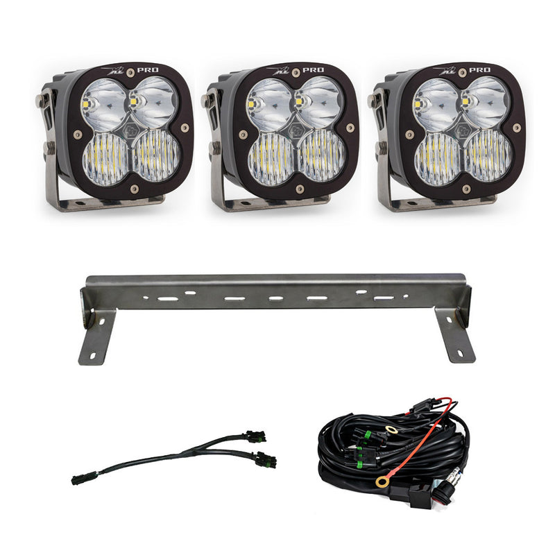Baja Designs XL Pro Bumper Kit, complete kit on a studio background: three XL Pro LED pods with clear lenses, a steel bumper mounting bar and wiring harnesses on a white background