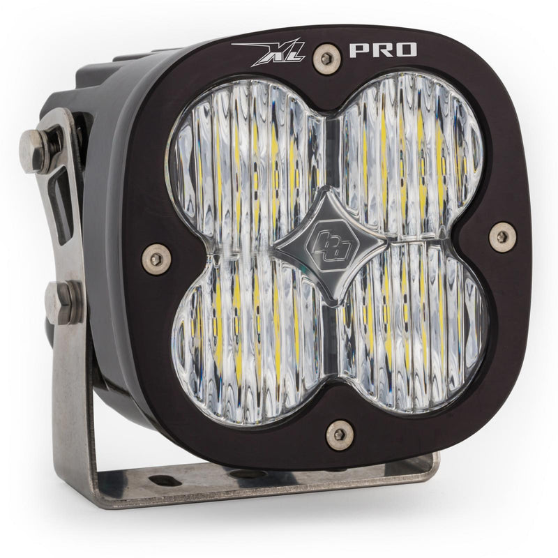 Baja Designs XL Pro LED Auxiliary Light Pod, whole product on a studio background: A black XL Pro LED light pod with a clear fluted wide cornering lens on a steel mounting bracket, on a white background