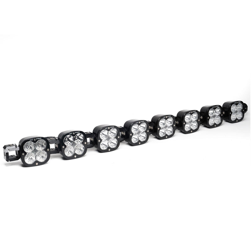 Baja Designs XL Pro Linkable LED Light Bar, whole product on a studio background: A 8-light black XL Pro Linkable LED light bar with clear lenses and end mounting blocks, shown at a front three-quarter angle on a white background