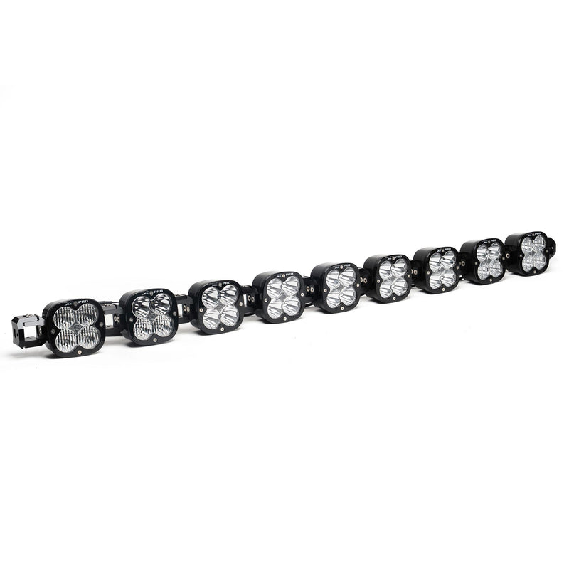 Baja Designs XL Pro Linkable LED Light Bar, whole product on a studio background: A 9-light black XL Pro Linkable LED light bar with clear lenses and end mounting blocks, shown at a front three-quarter angle on a white background