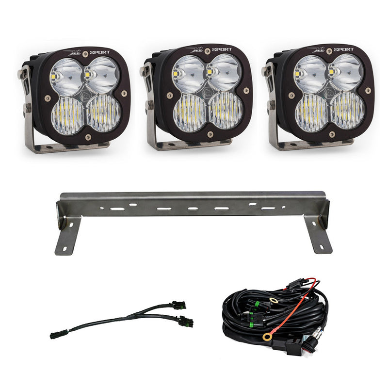 Baja Designs XL Sport Bumper Kit, complete kit on a studio background: three XL Sport LED pods with clear lenses, a steel bumper mounting bar and wiring harnesses on a white background