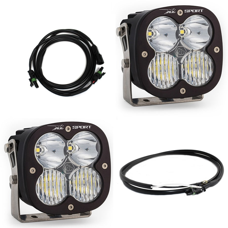 Baja Designs XL Sport Bumper Light Kit, complete kit on a studio background: two black XL Sport pods with clear lenses, a wiring harness and an extension cable on white