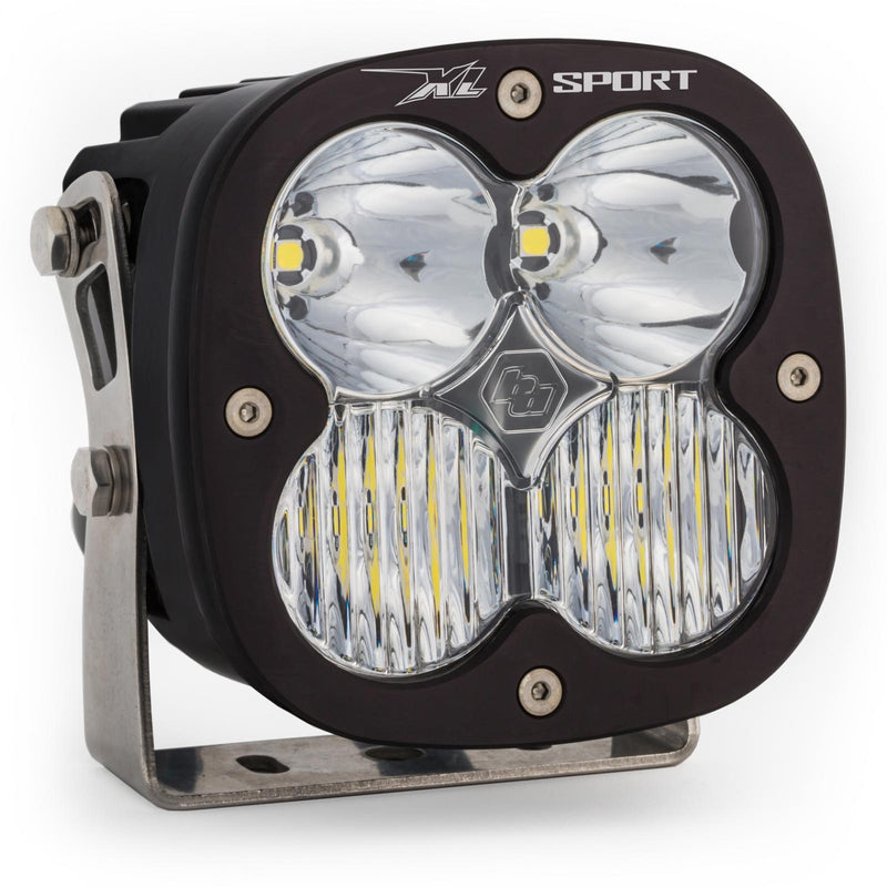 Baja Designs XL Sport LED Auxiliary Light Pod, whole product on a studio background: A single black square Baja Designs XL Sport LED light pod with a clear driving/combo lens on a steel mounting bracket, shown on white