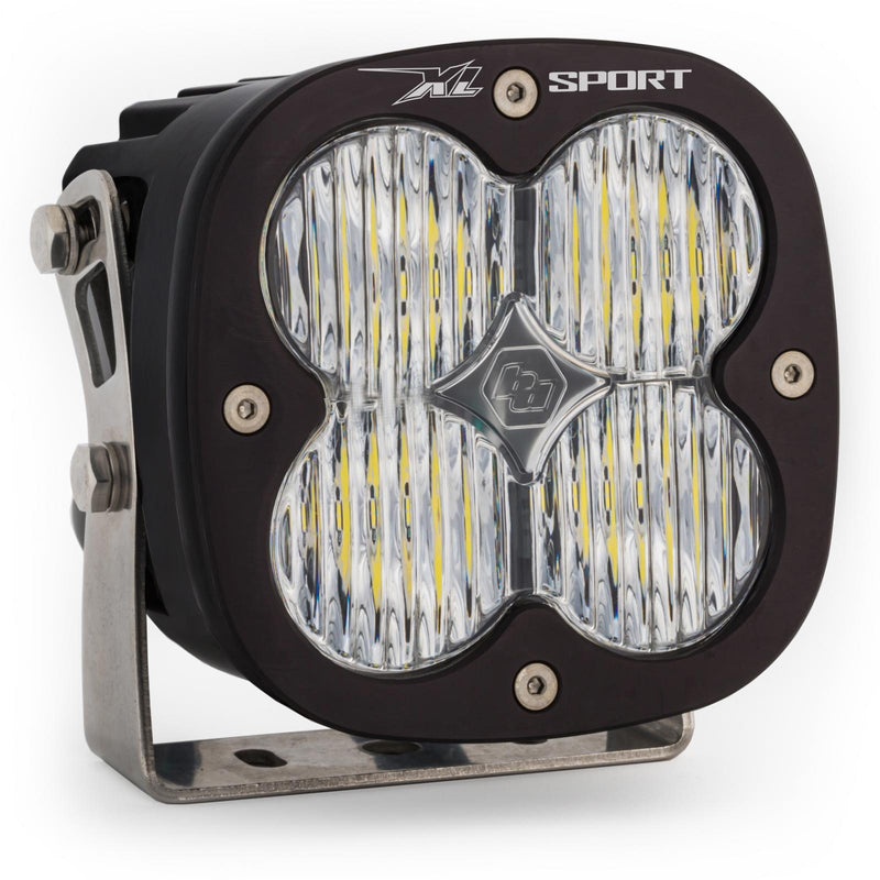 Baja Designs XL Sport LED Auxiliary Light Pod, whole product on a studio background: A single black square Baja Designs XL Sport LED light pod with a clear work/scene lens on a steel mounting bracket, shown on white
