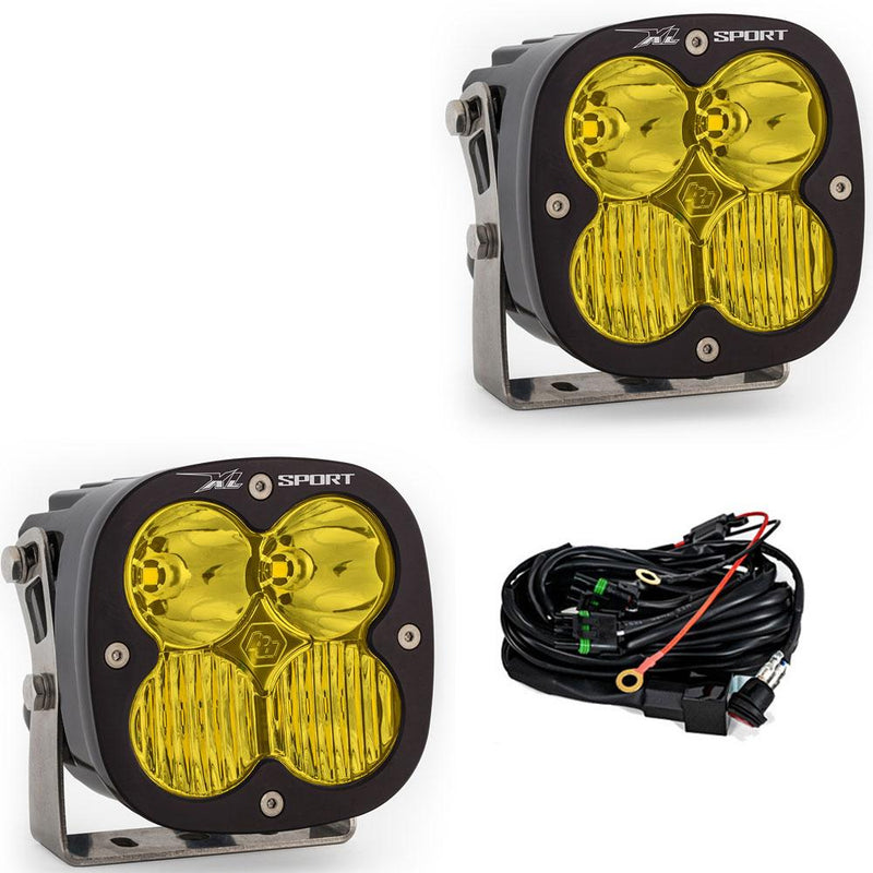 Baja Designs XL Sport LED Auxiliary Light Pod Pair, whole product on a studio background: A pair of black square Baja Designs XL Sport LED light pods with amber driving/combo lenses and a wiring harness, shown on white