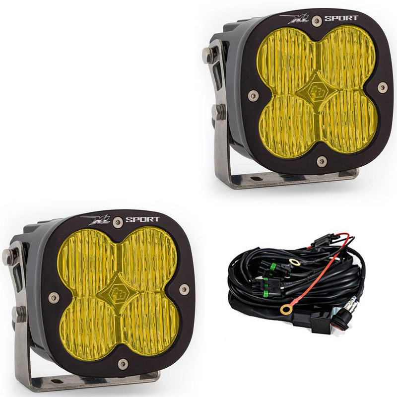 Baja Designs XL Sport LED Auxiliary Light Pod Pair, whole product on a studio background: A pair of black square Baja Designs XL Sport LED light pods with amber work/scene lenses and a wiring harness, shown on white