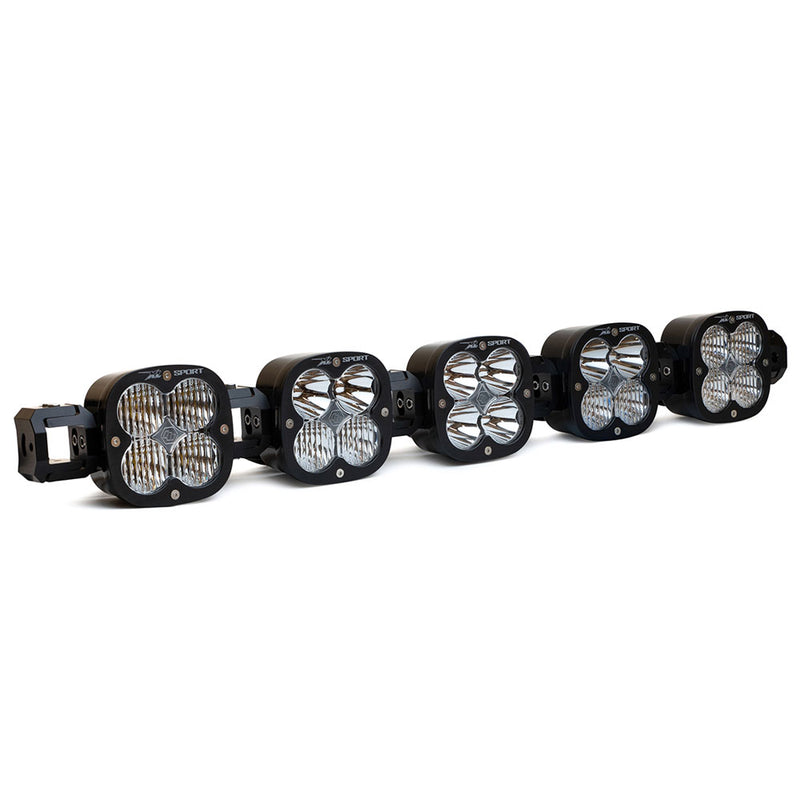 Baja Designs XL Sport Linkable LED Light Bar, whole product on a studio background: A 5-light black XL Sport Linkable LED light bar with clear lenses and end mounting blocks, shown at a front three-quarter angle on a white background