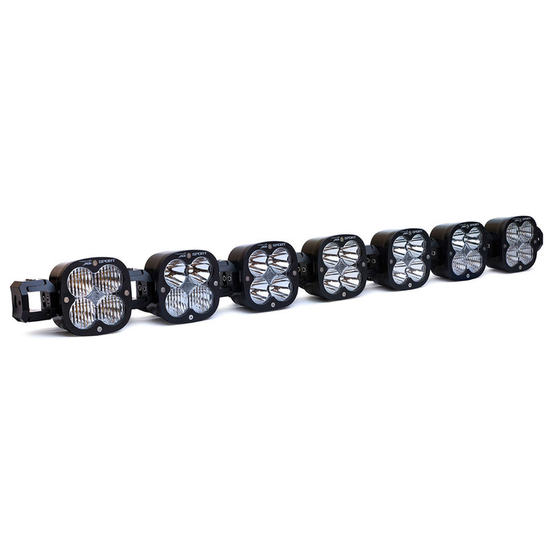 Baja Designs XL Sport Linkable LED Light Bar, whole product on a studio background: A 7-light black XL Sport Linkable LED light bar with clear lenses and end mounting blocks, shown at a front three-quarter angle on a white background