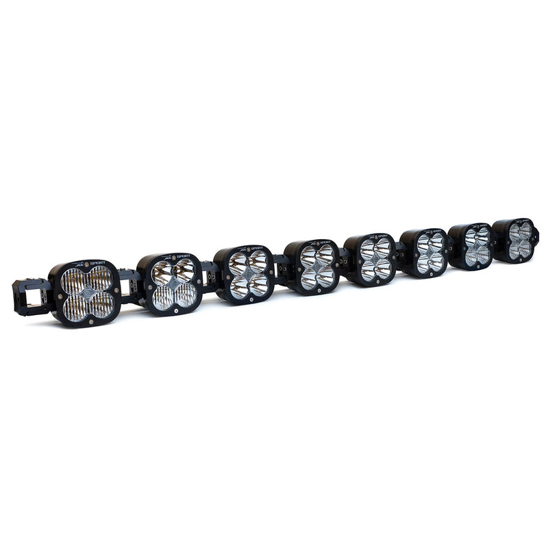 Baja Designs XL Sport Linkable LED Light Bar, whole product on a studio background: A 8-light black XL Sport Linkable LED light bar with clear lenses and end mounting blocks, shown at a front three-quarter angle on a white background