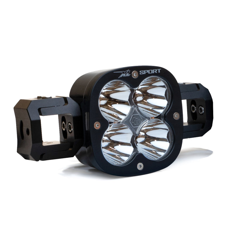 Baja Designs XL Sport Linkable LED Light Bar Add-a-Light, whole product on a studio background: A single black XL Sport light pod with linking blocks on both sides and clear lenses on a white background