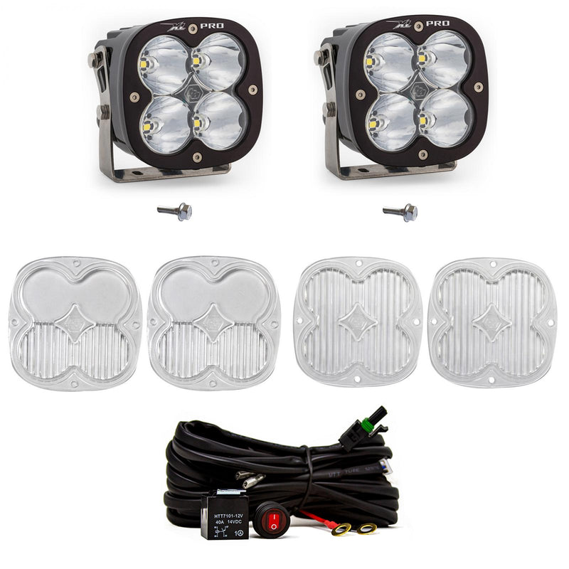 Baja Designs XL80 A-Pillar Light Kit, complete kit on a studio background: two black XL Pro pods with clear lenses (XL Pro shown; this kit ships with XL80 pods), shown with mounting bolts, four clear lens covers and a switched relay harness on white