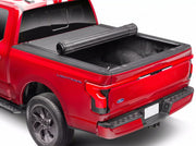 BAK Revolver X4s tonneau cover partially rolled open on a red Ford F-150 Lightning, with the black slatted cover half retracted toward the cab and the rear of the bed uncovered