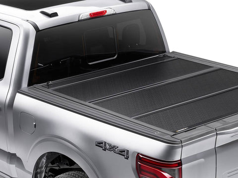 BAKFlip F1 hard folding tonneau cover fully closed on a silver pickup, rear three-quarter view