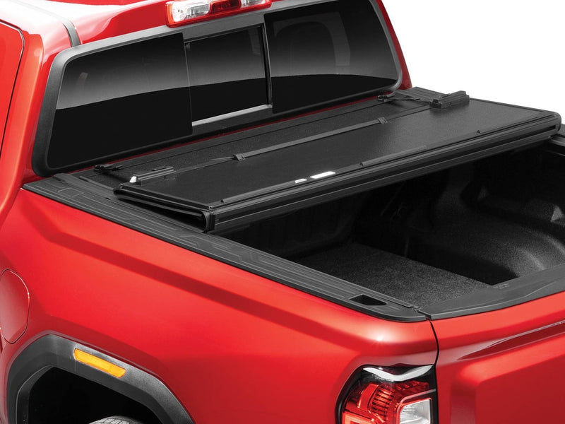 BAKFlip G2 hard folding tonneau cover on a red pickup, rear panels folded forward to open the back of the bed