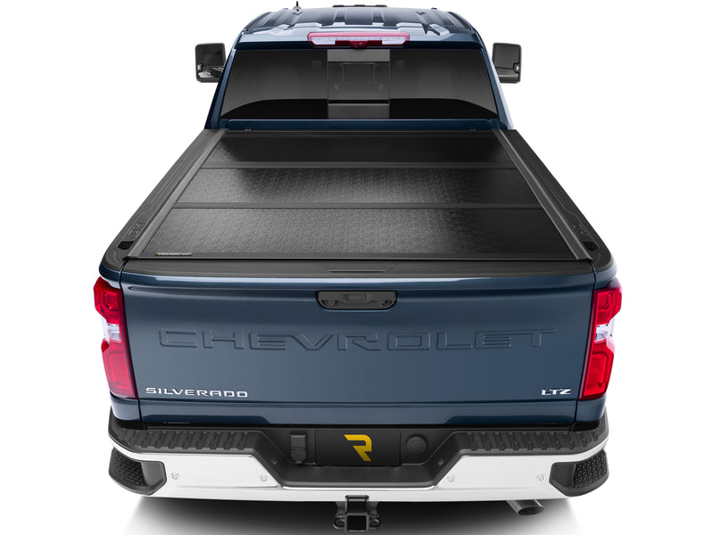 UnderCover Flex hard folding tonneau cover closed and flush across the full bed width, straight rear view.