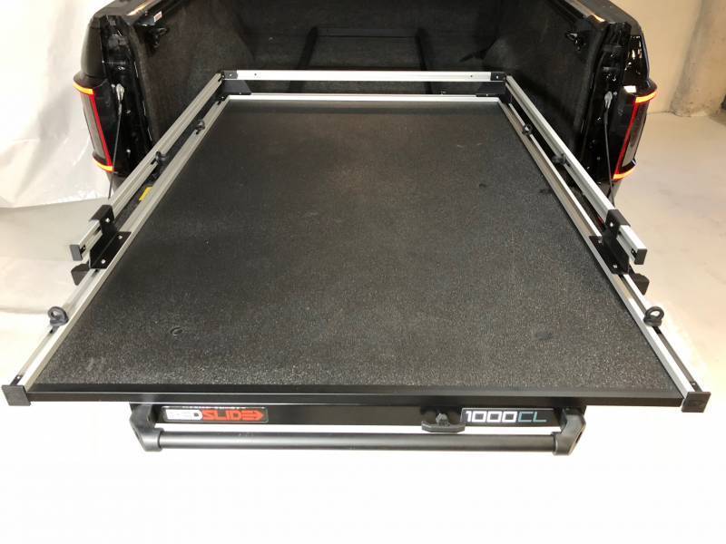 BEDSLIDE 1000 Classic cargo slide in Silver finish shown from above in a pickup bed with the 1000CL badge visible