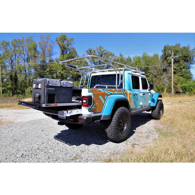 Rear three quarter view of a Jeep Gladiator with a BEDSLIDE cargo slide in Silver finish extended and loaded
