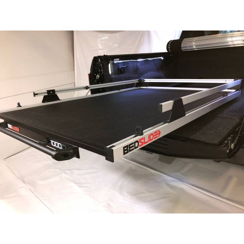 BEDSLIDE 1000 Classic cargo slide in Silver finish angled out of a pickup bed with the 1000 badge visible