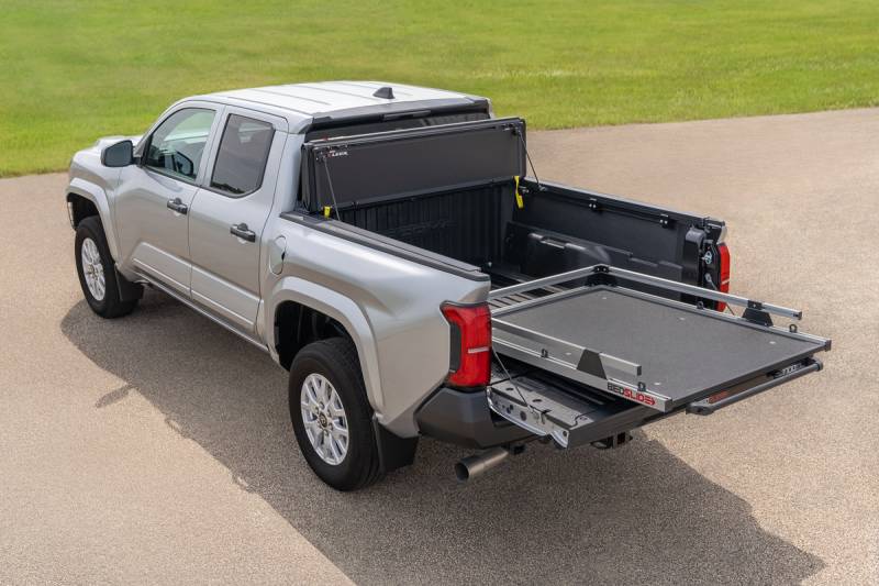Silver Toyota Tacoma with a BEDSLIDE cargo slide in Silver finish extended out of the bed