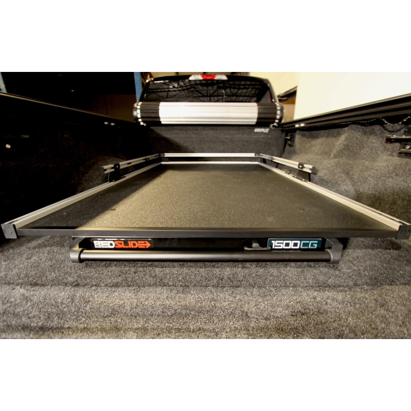 BEDSLIDE 1500 Contractor cargo slide in Silver finish seated in a pickup bed with the 1500CG badge visible
