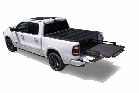 White Ram 1500 with a BEDSLIDE MAX Extension cargo slide in Black Edition finish extended fully clear of the tailgate
