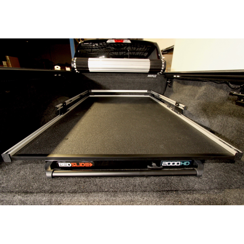 BEDSLIDE 2000 Heavy Duty cargo slide in Silver finish seated in a pickup bed with the 2000HD badge visible