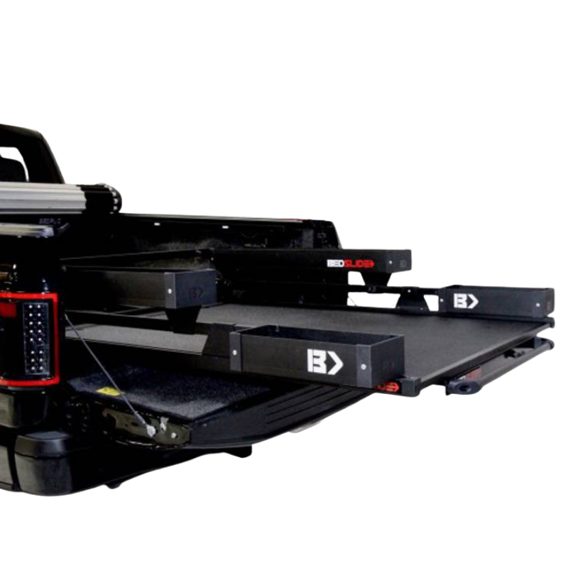 Black Edition BEDSLIDE deck extended from a truck bed with the black BEDBIN kit fitted, closer crop of the rear quarter view.