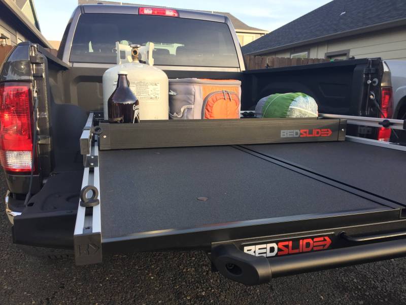 Black Edition deck divider placed across an extended BEDSLIDE deck with gear stacked behind it