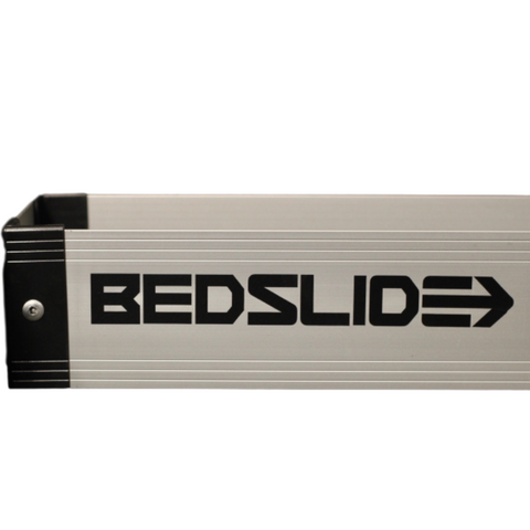Silver BEDSLIDE BEDBIN deck divider, studio close-up on white showing the aluminum extrusion, black end cap and the BEDSLIDE decal