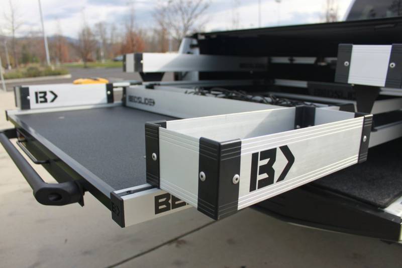 Silver Mini Kix bins fitted outboard on an extended BEDSLIDE deck, photographed from the rear